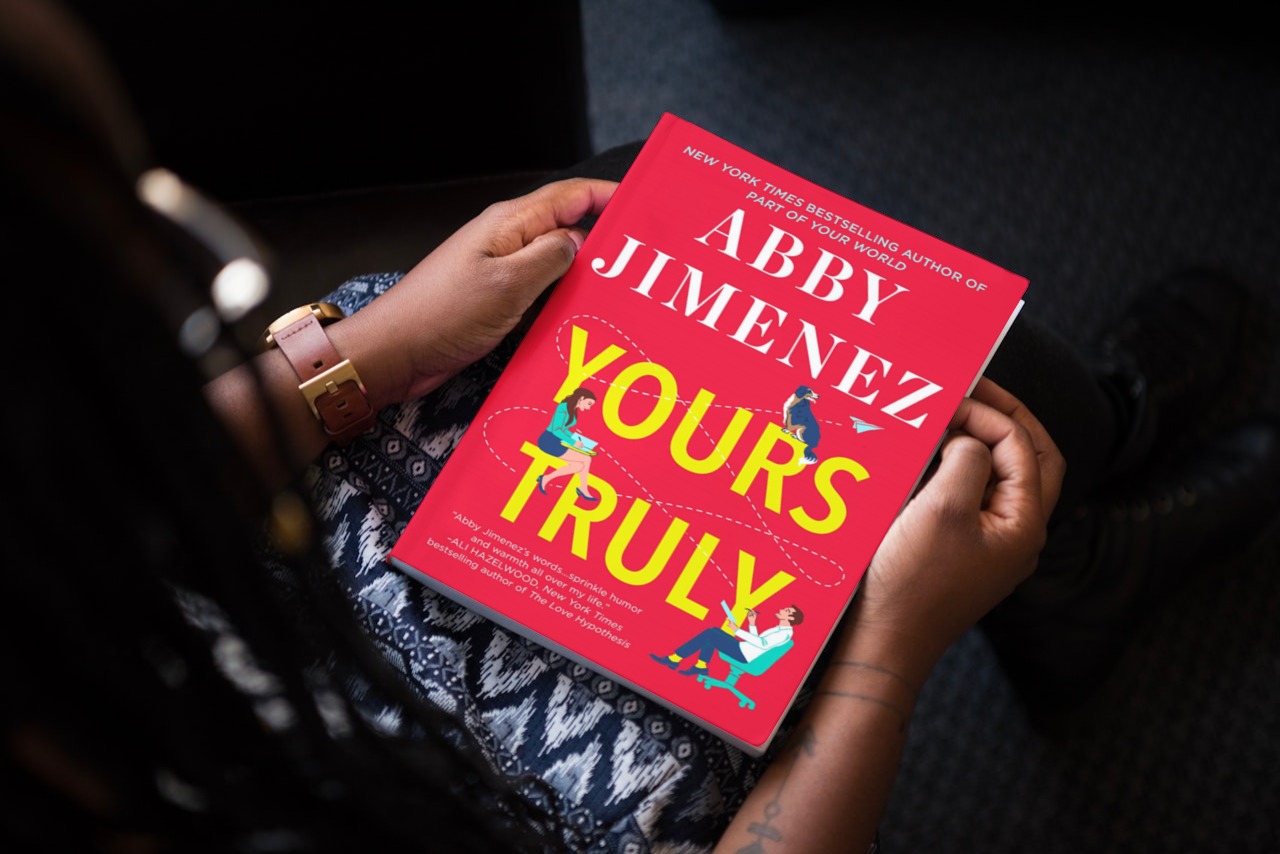 Woman holds a book on her lap